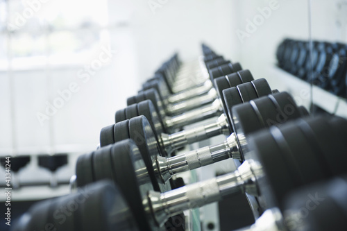 Photo: Close up of dumbbells in health club Close up of dumbbells in health club
