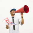 Hispanic man waving American flag and talking into megaphone