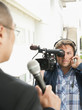 Camera man filming news reporter