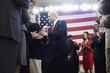 Caucasian politician shaking hands with supporters