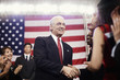 Caucasian politician shaking hands with supporters