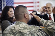 Soldier saluting politician at political gathering