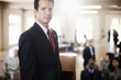 Serious businessman standing in meeting room