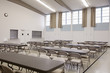 Tables and chairs in empty cafeteria