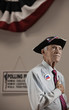 Caucasian man pledging allegiance in polling place