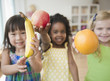 Children holding out fresh fruit