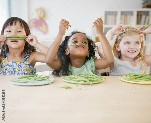 Photo: Girls playing with green beans Girls playing with green beans