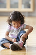 Hispanic girl tying her shoes