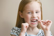Girl flossing teeth with dental floss
