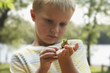 Caucasian boy looking at small frog