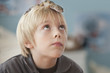 Caucasian boy with lizard on his head