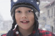 Smiling Caucasian boy standing in snow