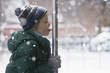 Caucasian boy licking metal pole in the snow