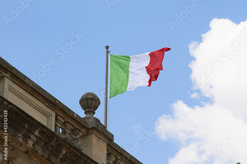 Photo: Italian flag fluttering on rooftop Italian flag fluttering on rooftop