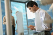 Indian businessman text messaging on cell phone