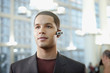 Foto: Hispanic businessman wearing hands-free cellular device Hispanic businessman wearing hands-free cellular device