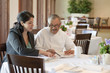 Hispanic business owner talking to restaurant chef