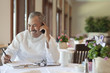 Hispanic chef working on paperwork in restaurant
