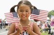 Caucasian girl waving American flags