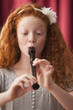 Mixed race girl playing recorder