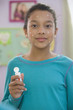 Hispanic girl putting on acne cream