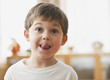 Cute Caucasian boy sticking out tongue