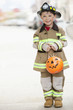Caucasian boy dressed in fireman Halloween costume