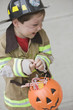 Caucasian boy dressed in fireman Halloween costume