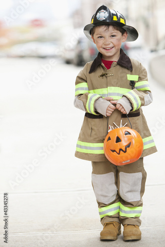Photo: Caucasian boy dressed in fireman Halloween costume Caucasian boy dressed in fireman Halloween costume