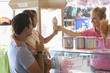 Waitress handing ice cream cone to young girl