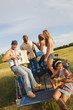 Friends playing musical instruments on back of truck