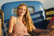 Caucasian woman sitting in back of truck