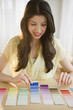 Mixed race woman looking at paint swatches