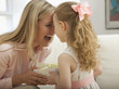 Caucasian daughter giving mother a gift