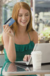 Caucasian teenager shopping online with credit card