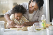 Mother and daughter baking in kitchen
