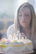 Foto: Caucasian teenage girl blowing out birthday candles Caucasian teenage girl blowing out birthday candles