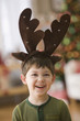 Caucasian boy in antler costume
