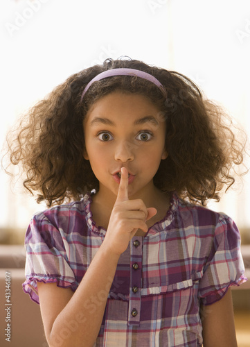 Photo: Mixed race girl making shhh gesture Mixed race girl making shhh gesture
