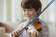 Smiling boy playing violin
