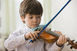 Serious boy playing violin