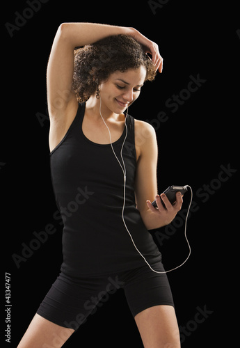 Photo: Caucasian woman listening to mp3 player Caucasian woman listening to mp3 player