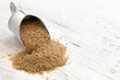 Photo: Scoop of Brown Rice on Rustic White Timber Scoop of Brown Rice on Rustic White Timber
