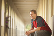 Caucasian man sitting outdoors laughing