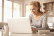Hispanic woman typing on laptop