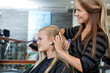 Hairdresser Combing Hair Of Female