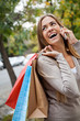 Woman On A Call While Carrying Shopping Bags
