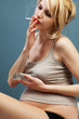 Pretty pregnant with a cigarette and ashtray