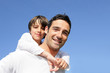 Boy riding piggy back on his father's back