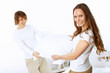 Young couple fighting with pillows
